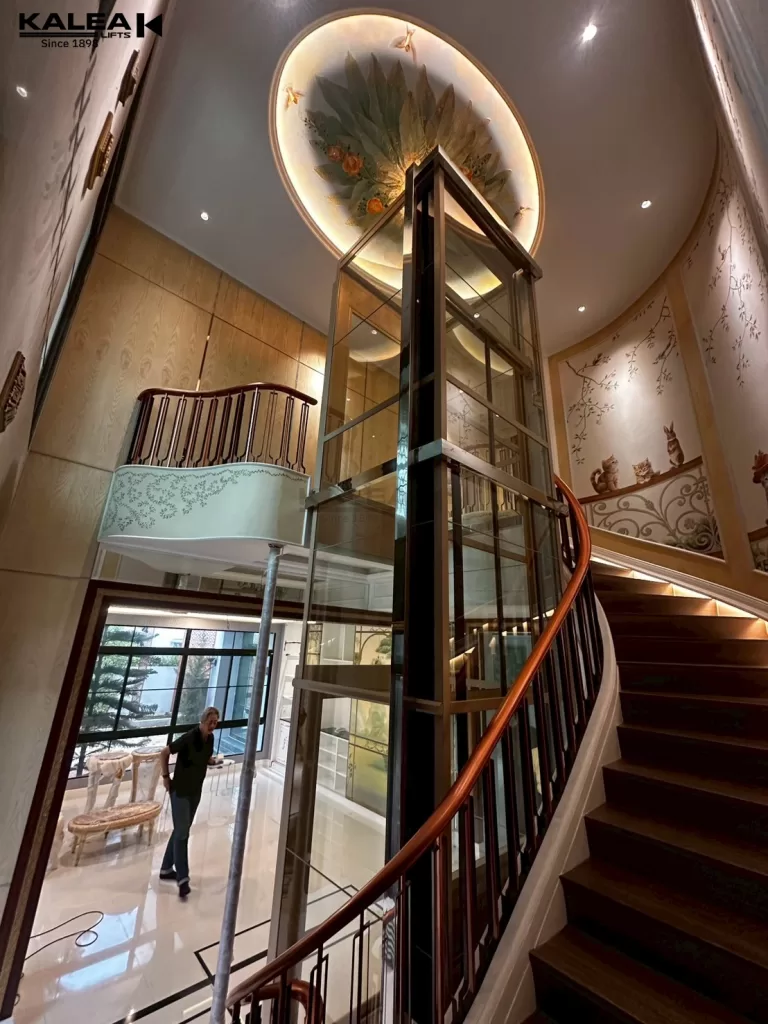 Instalasi Kalea X80 pada void tangga melingkar, menunjukkan efisiensi ruang tanpa mengganggu estetika interior rumah.
